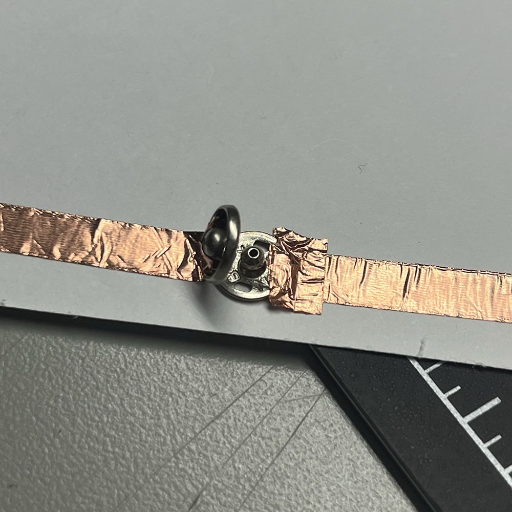 Making test of low voltage electricity using metal button close in detail #2.